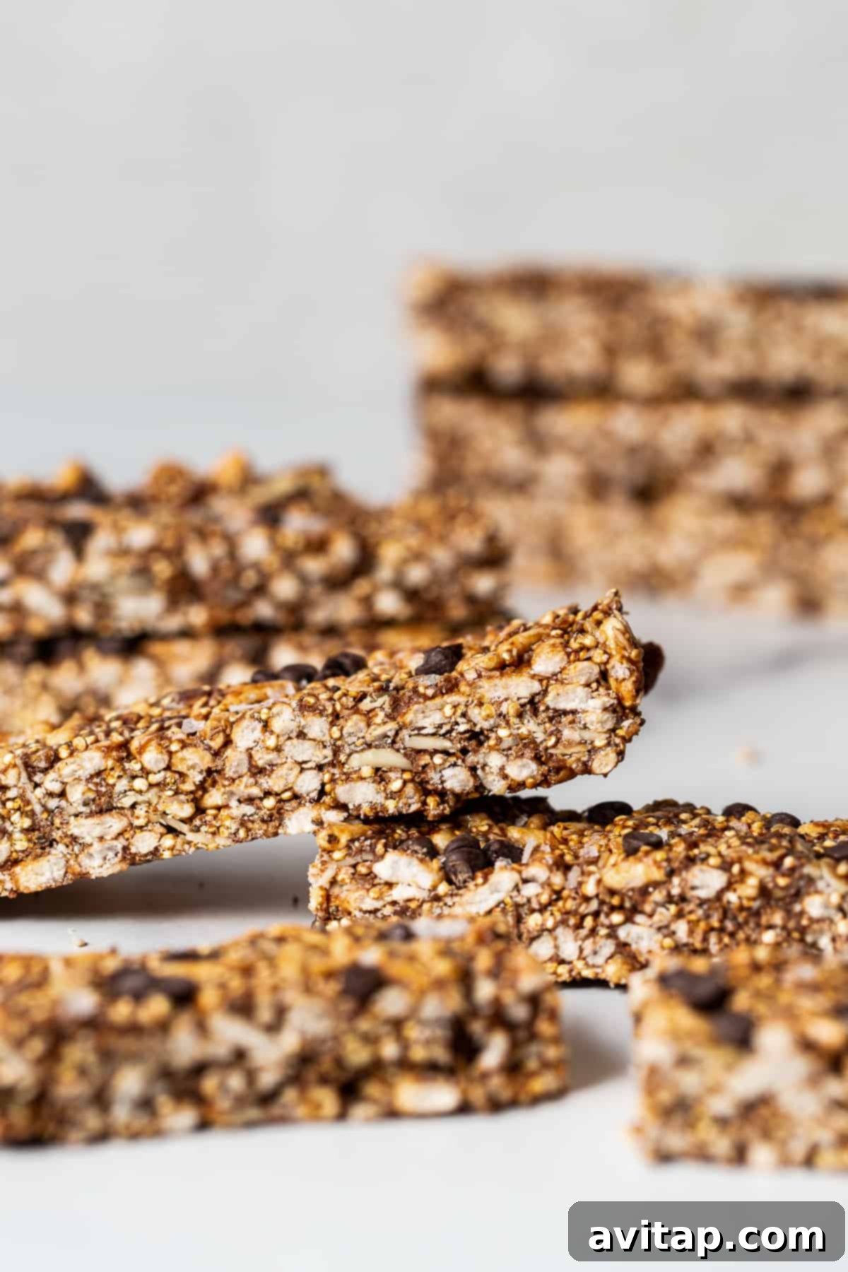 Stacked nut and coconut bars, showing the crunchy texture of puffed brown rice.