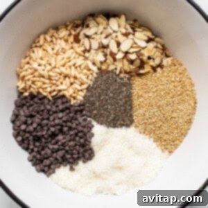 Dry ingredients for nut and coconut bars in a mixing bowl.