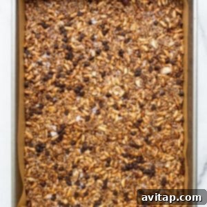 Nut and coconut bar mixture pressed into a 9x13-inch pan.