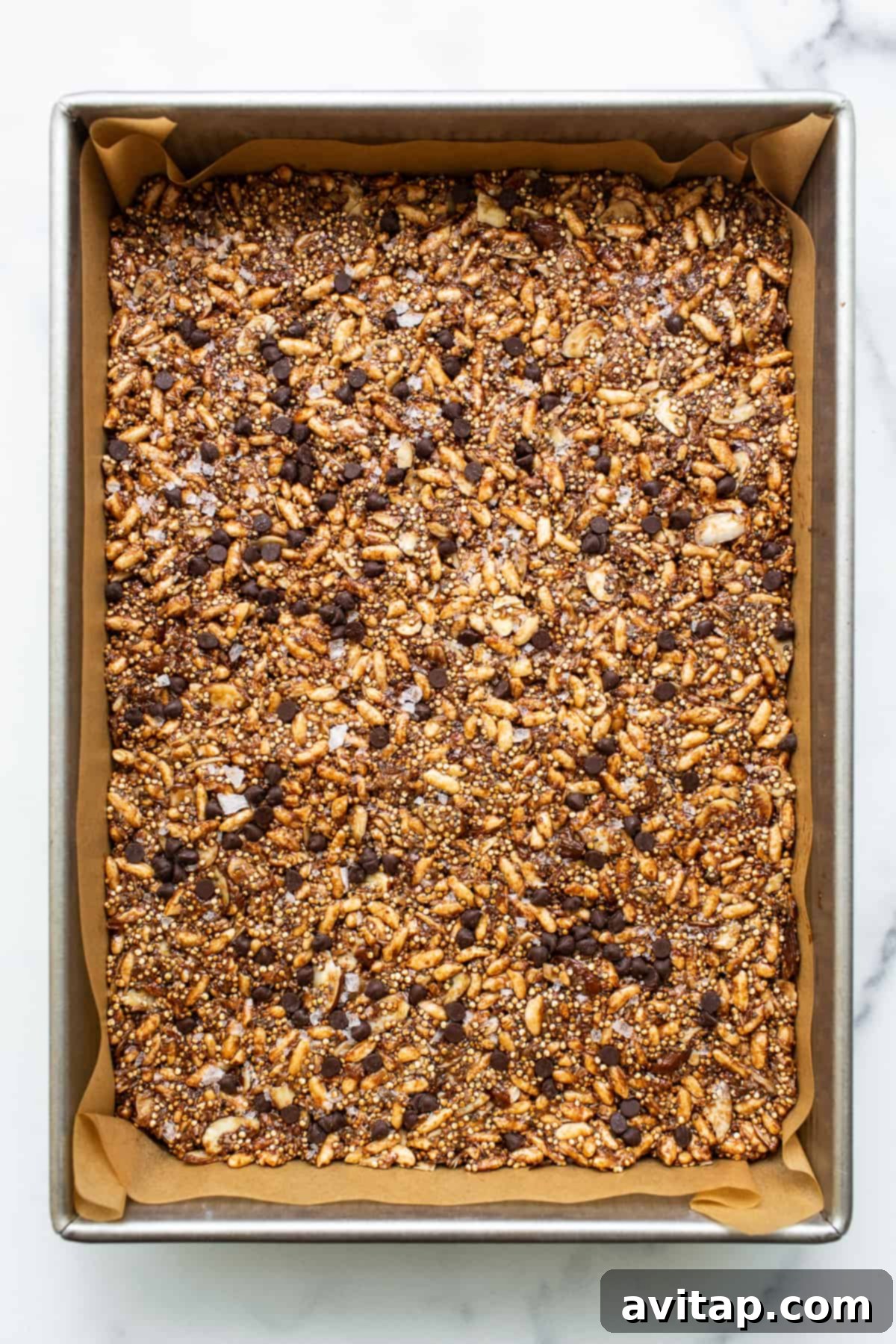 Set nut and coconut bars in a 9x13-inch pan, ready for slicing.