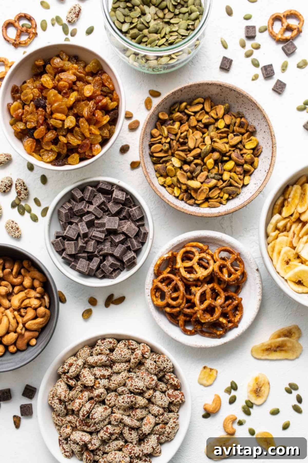 Homemade trail mix ingredients in bowls.