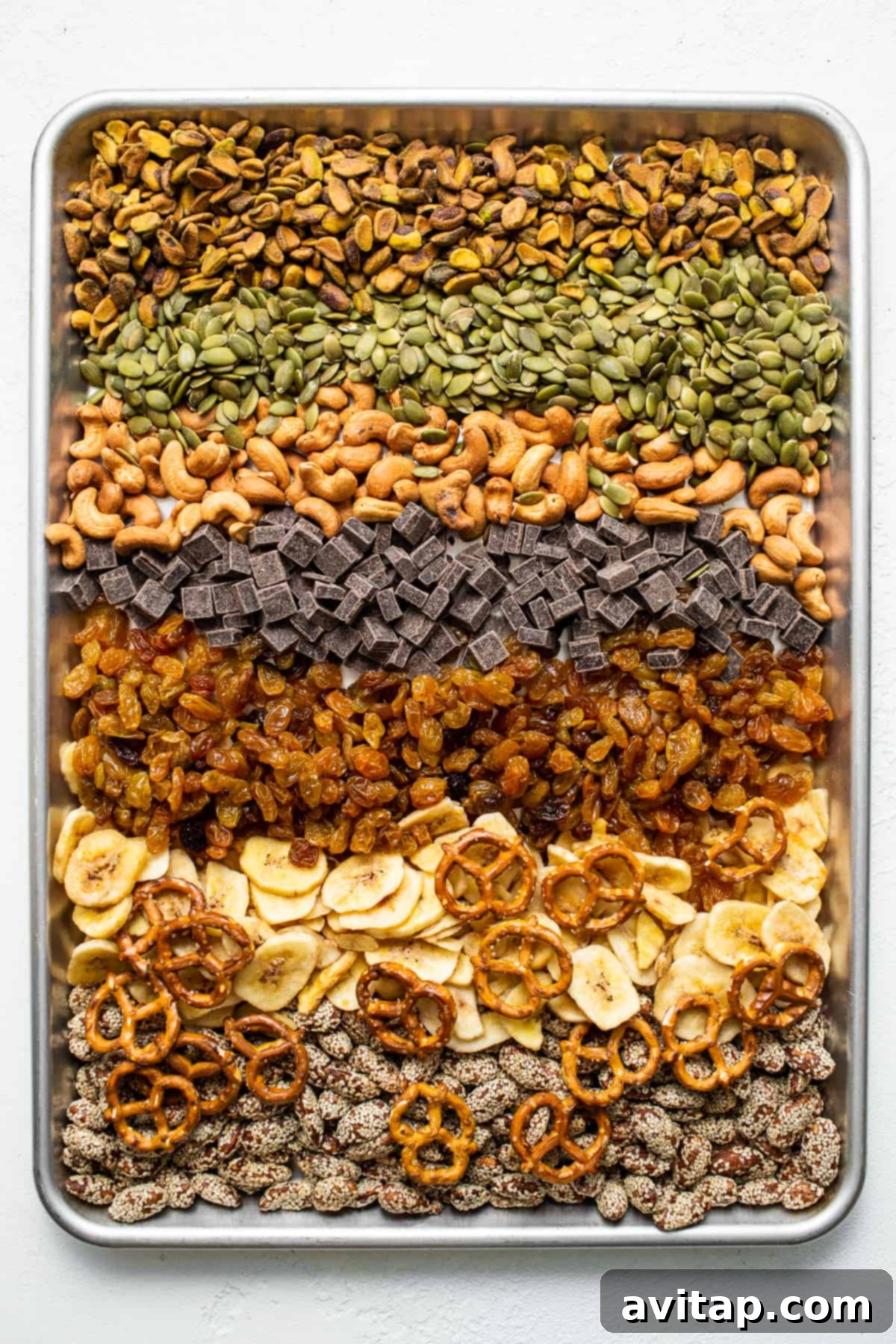 Homemade trail mix ingredients on a baking sheet.