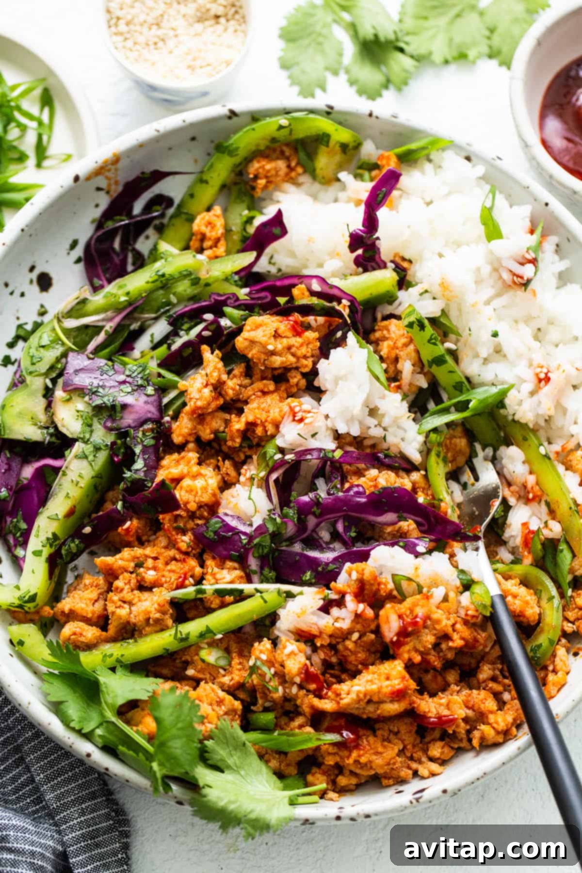 Close-up of a vibrant ground chicken bowl garnished with fresh cilantro, ready to be enjoyed.