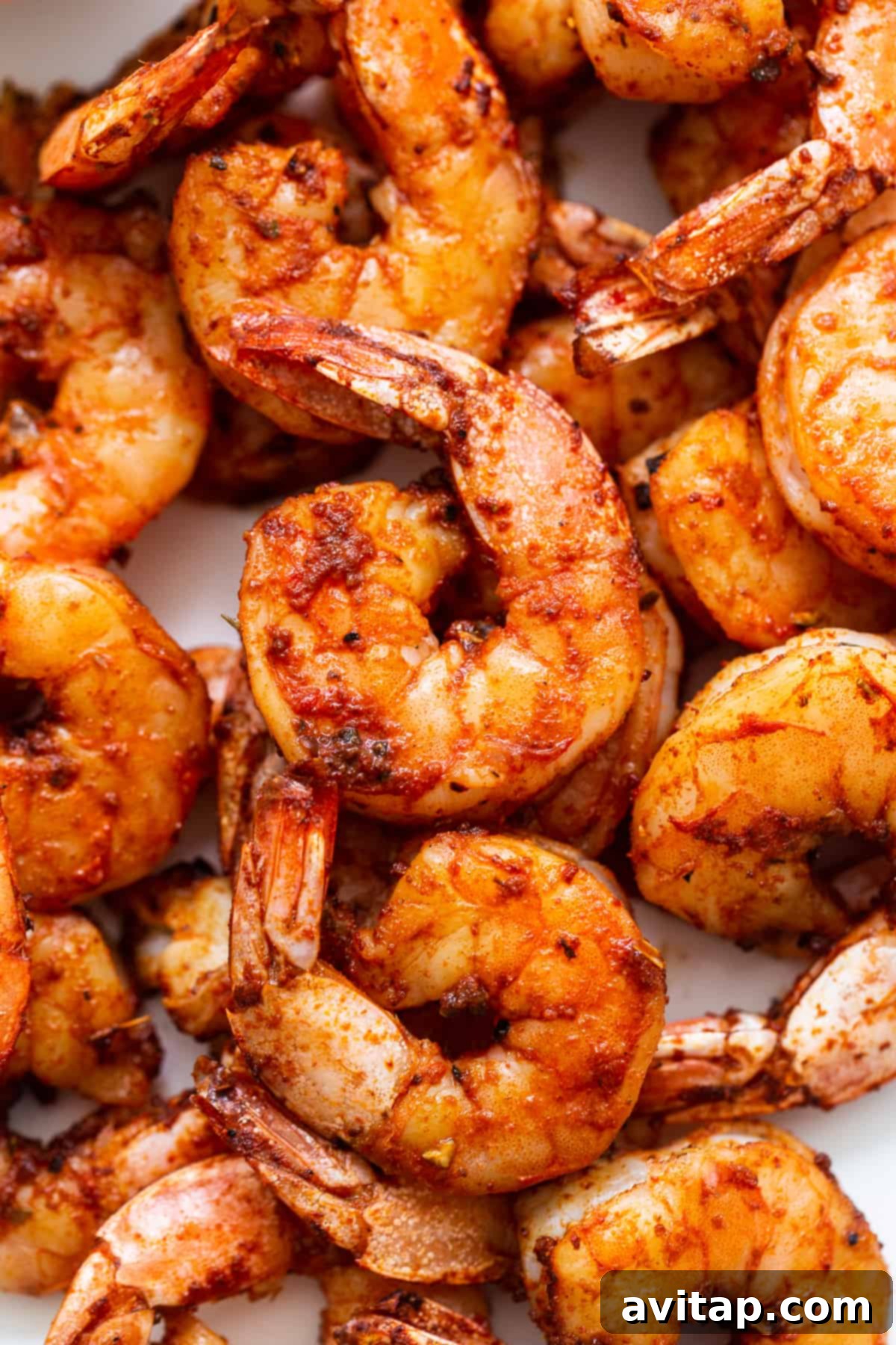 Beautifully stacked broiled shrimp. A stack of perfectly broiled shrimp, golden and inviting.