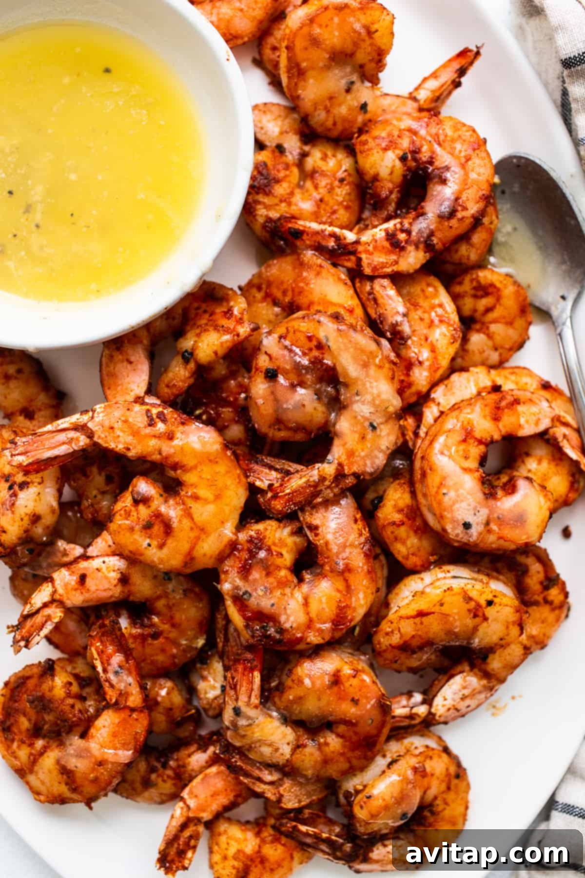 Broiled shrimp served with honey butter sauce. A plate of perfectly broiled shrimp served with a small bowl of heavenly honey butter sauce.