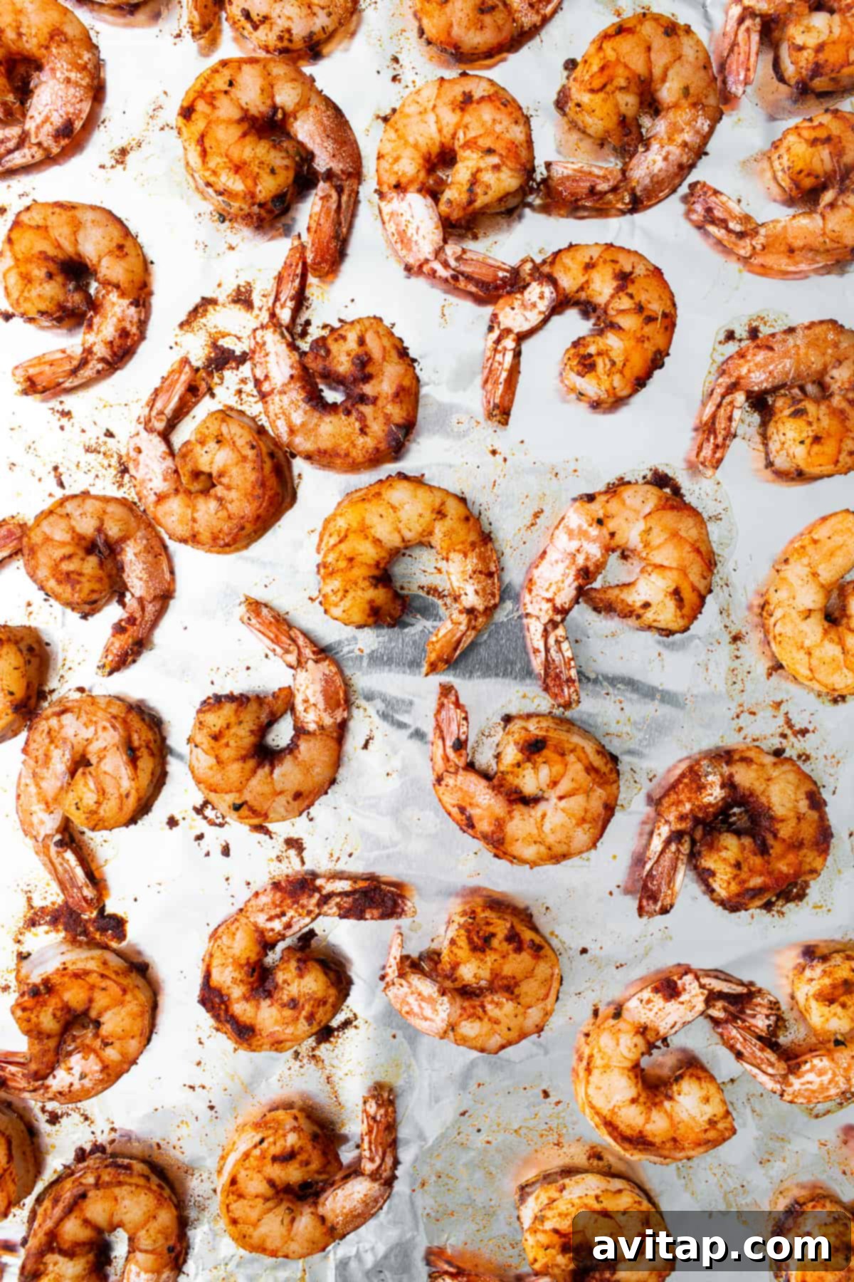 Broiled shrimp on a baking sheet after cooking. Freshly broiled shrimp presented on a baking sheet, showcasing its perfect color and texture.