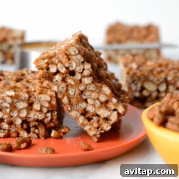 Peanut butter granola bars on an orange plate, showcasing healthy chocolate peanut butter crispy treats.