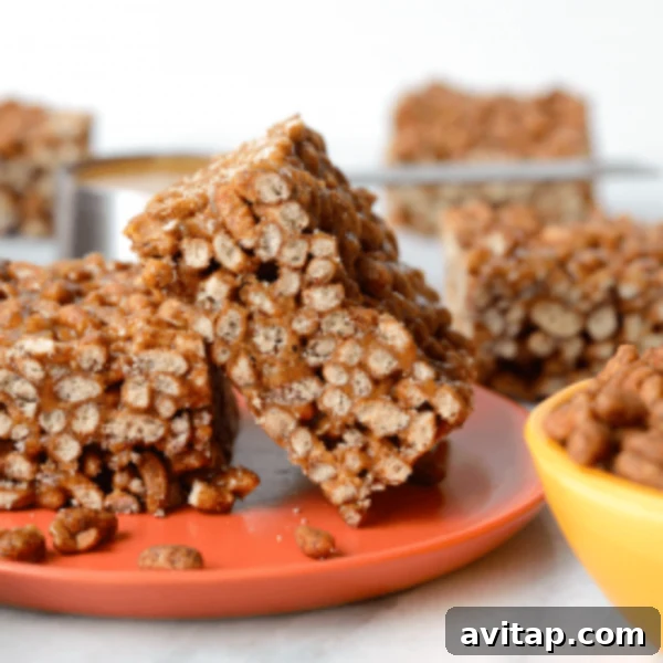 Chocolate Peanut Butter Brown Rice Crispy Bars 5 A perfectly portioned serving of healthy chocolate peanut butter crispy treats on an orange plate, ready to be enjoyed.