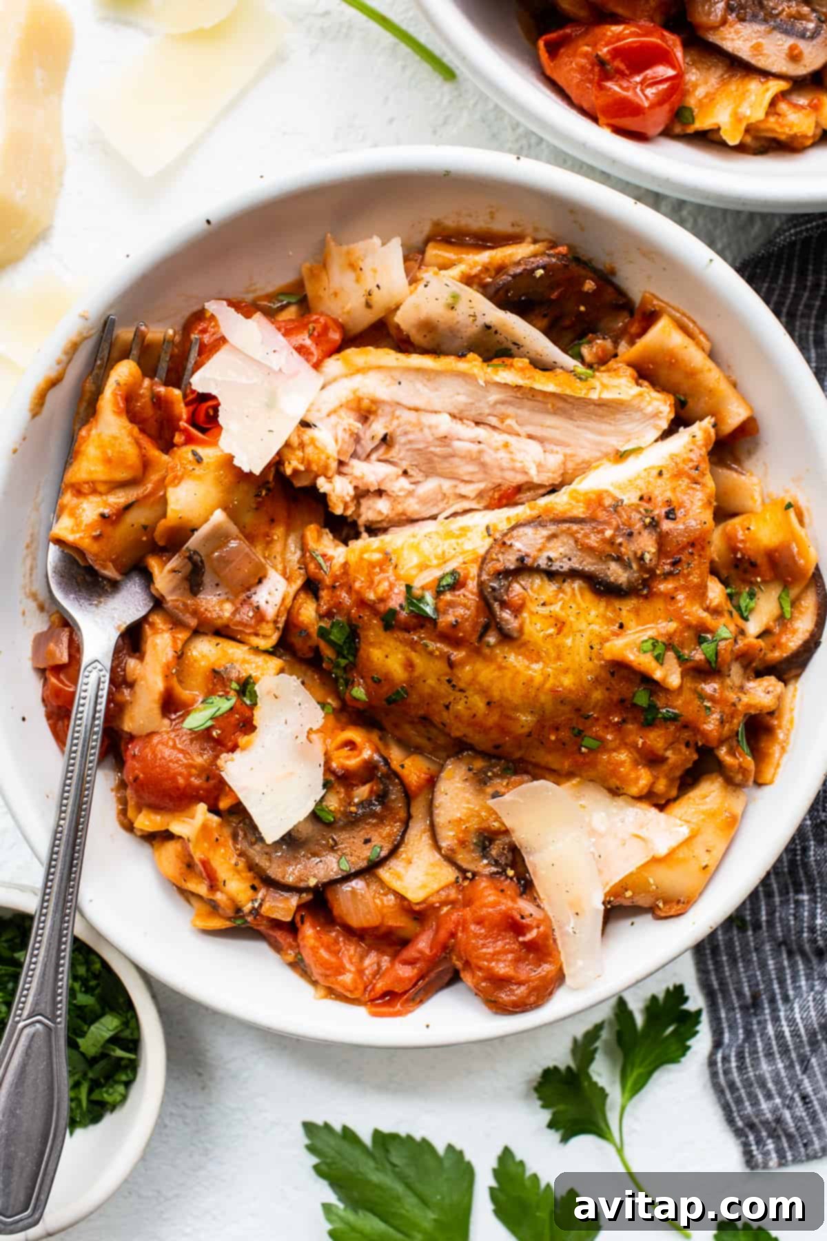A close-up shot of creamy one-pot pappardelle pasta with tender chicken thighs in a bowl, ready to be enjoyed.