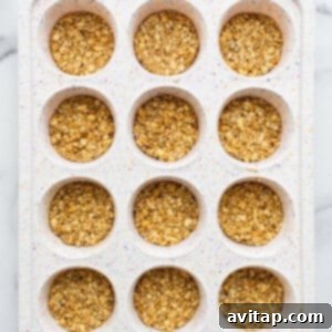 Oatmeal layer topped with chocolate in a muffin tin.