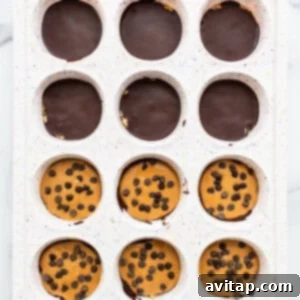 Peanut butter layer added to the no-bake cups in a muffin tin.