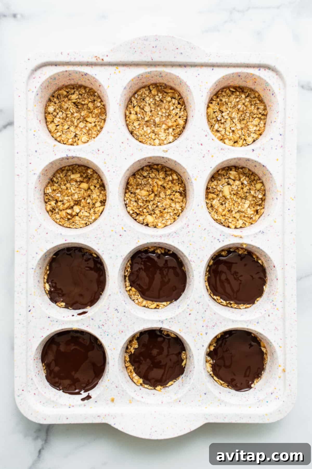 Freshly made oat cups chilling in a muffin tin.