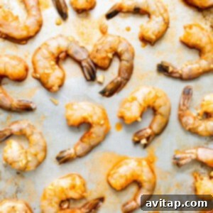 Marinated shrimp on a baking sheet.