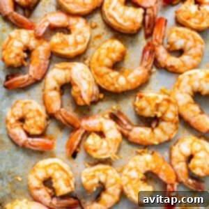 Grilled shrimp on a baking sheet after broiling.