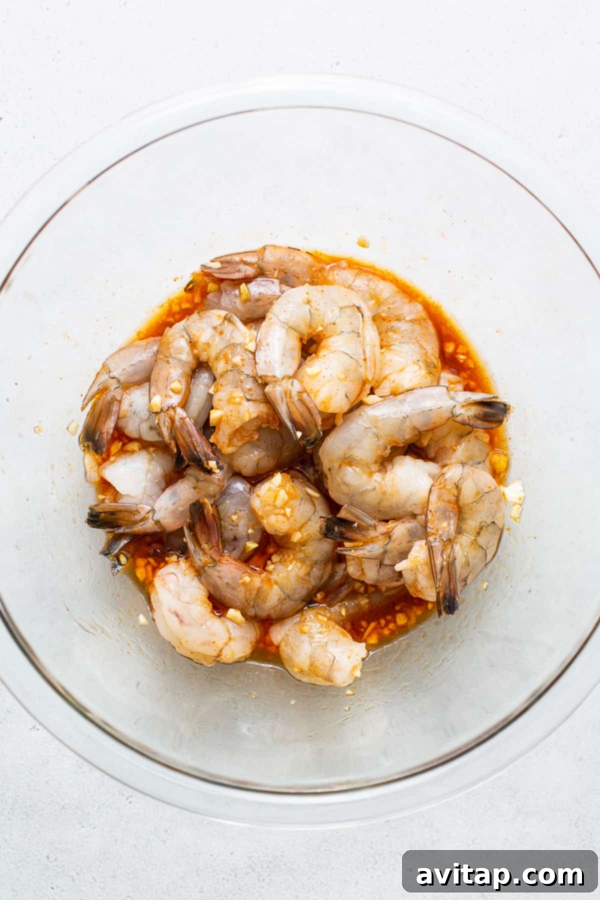 Prawns Marinating in Chili Garlic Sauce Raw prawns beautifully marinating in a glass bowl, absorbing the chili garlic sauce.