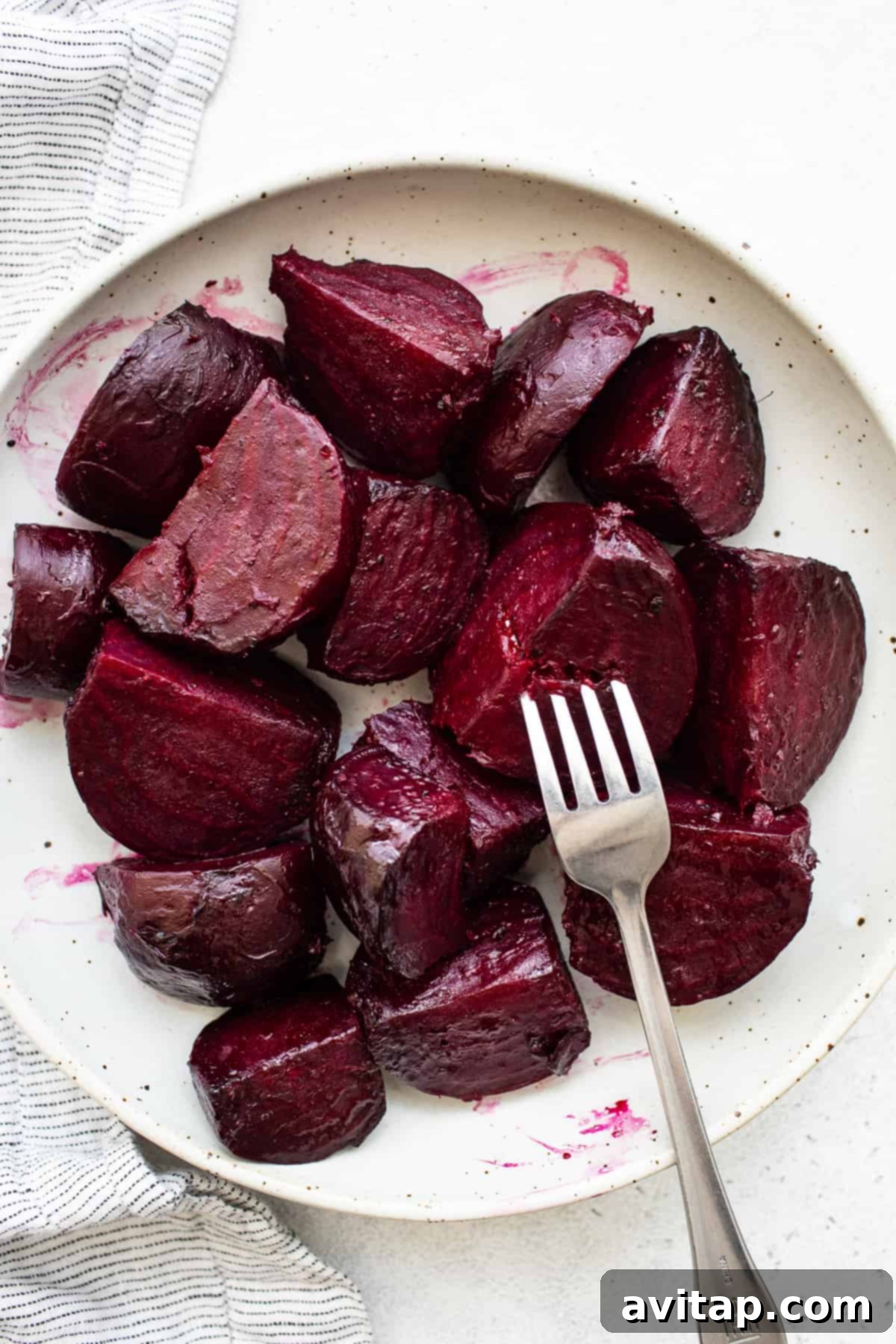 Perfectly roasted beets on a white plate, ready to serve.