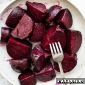 Sliced roasted beets arranged beautifully on a plate.