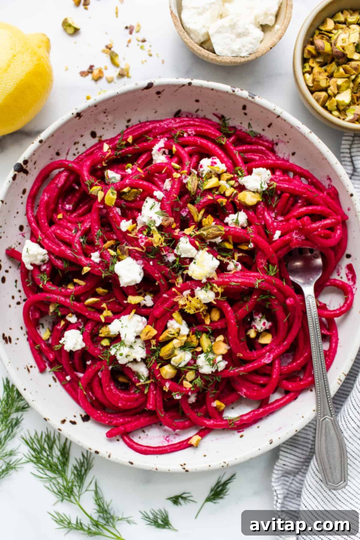 Roasted Beet Pasta: A Delicious and Eye-Catching Viral Pink Pasta Recipe A bowl of vibrant roasted beet pasta garnished with fresh herbs and crumbled goat cheese.