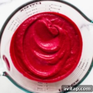 Beet puree in a measuring cup.