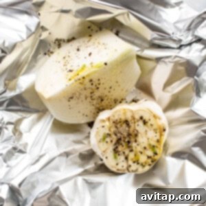 A piece of potato wrapped in foil with spices.