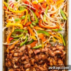 Sheet pan chicken fajitas, freshly baked and broiled, showcasing caramelized vegetables and chicken.