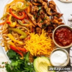 A large platter presenting cooked chicken fajitas with tortillas and various toppings.
