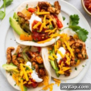 Delicious chicken fajitas beautifully arranged on a plate.