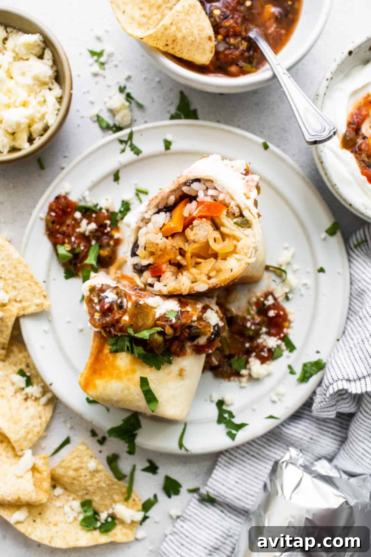 Chicken fajita burrito on a plate, ready to be enjoyed.