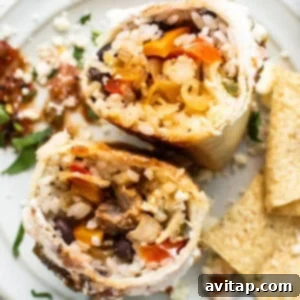 Chicken fajita burrito on a plate.