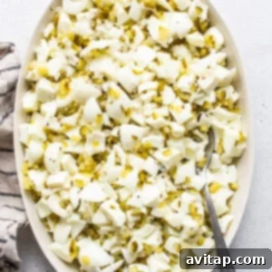 A bowl of shredded cabbage with a spoon on a table.