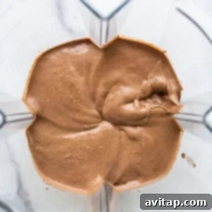 Chocolate mousse-like mixture being blended in a high-speed blender.