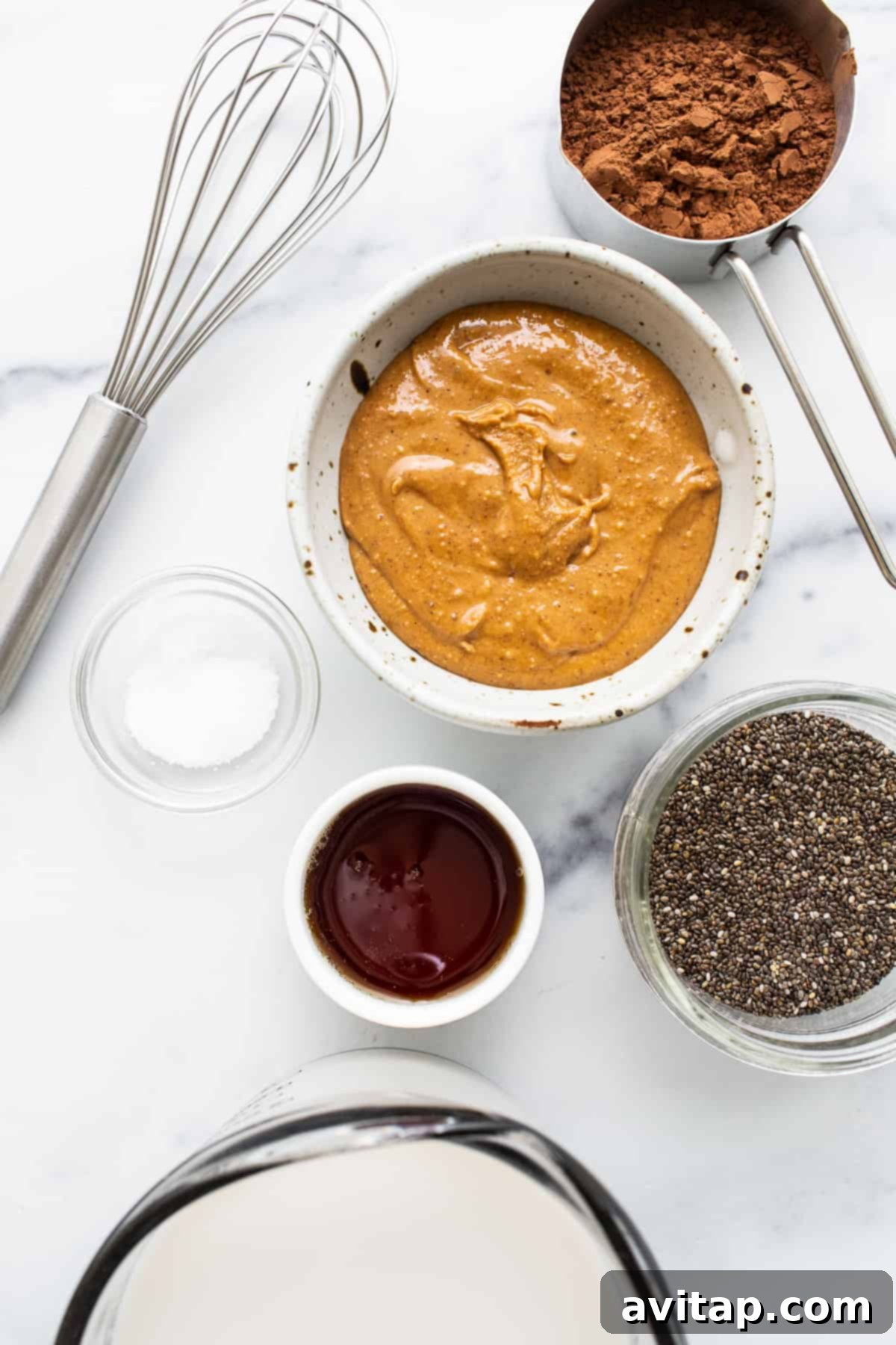 An inviting overhead shot showcasing the key ingredients for blended chia seed pudding neatly arranged in individual bowls, ready for preparation.