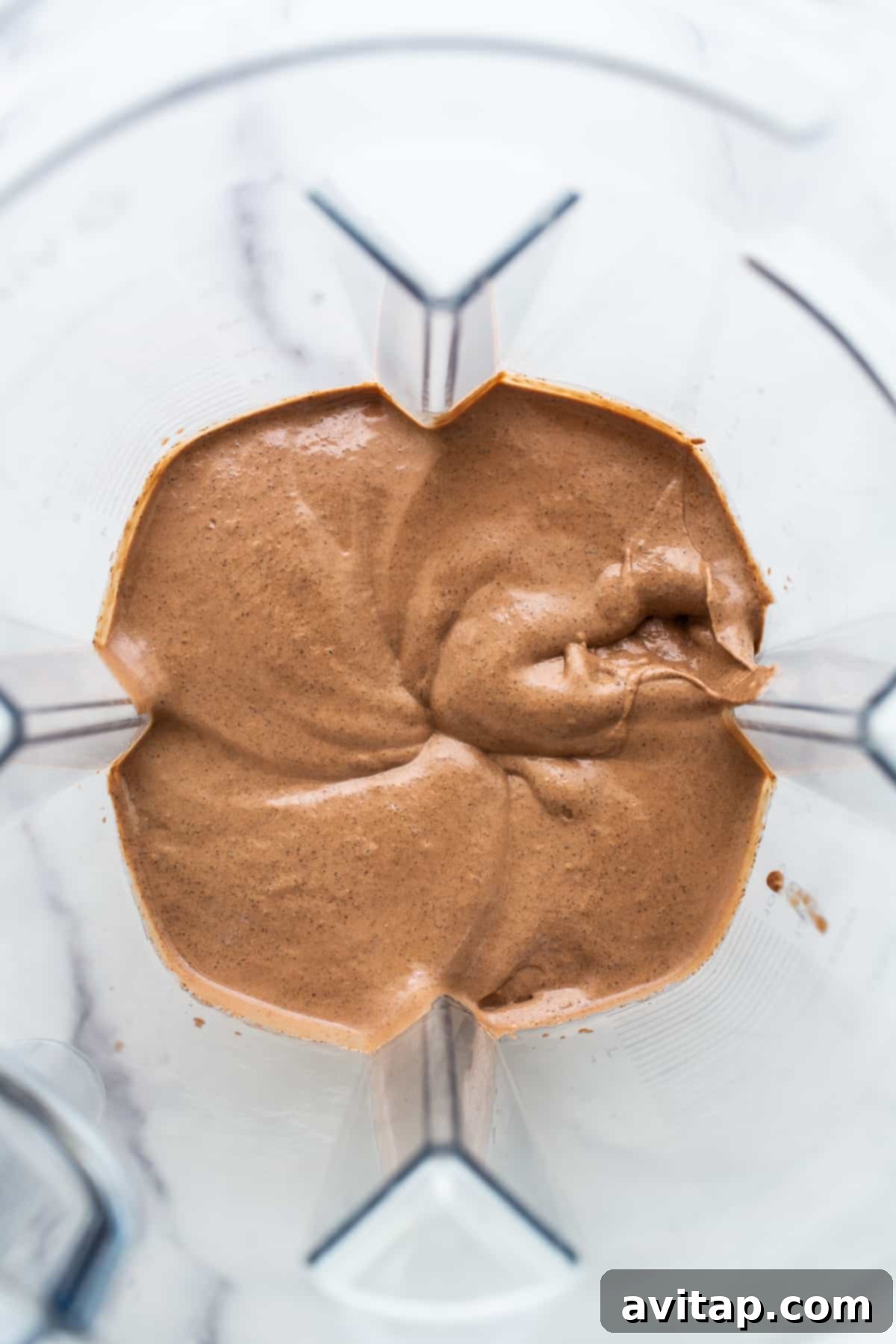 The blended chia seed pudding being processed in a high-speed blender, creating a smooth and creamy texture.