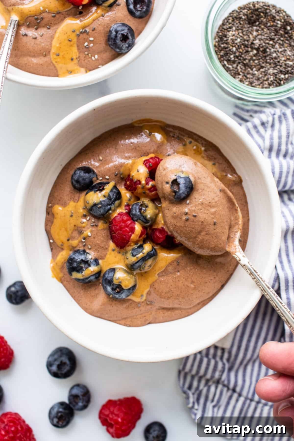 A close-up shot of blended chia seed pudding served in a bowl with a spoon, highlighting its creamy texture and inviting presentation.