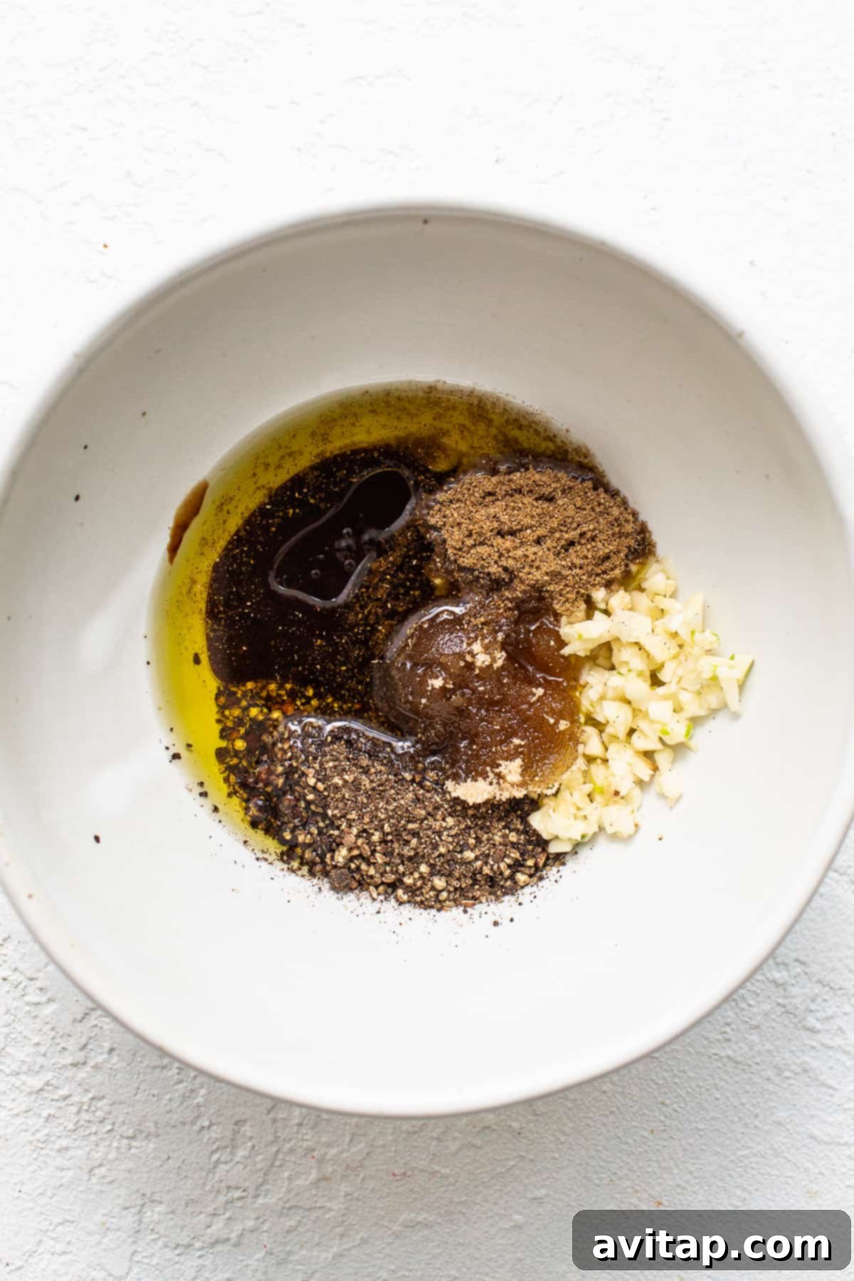 All the ingredients for skirt steak marinade whisked together in a mixing bowl, ready for the beef.