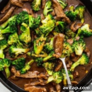 Cooked beef and broccoli combined in the pan with the thickened sauce.