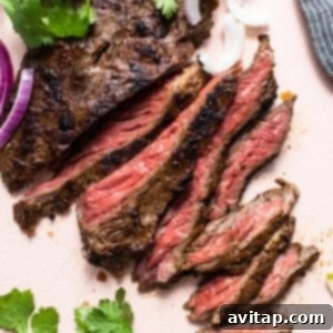 Slices of skirt steak on a cutting board, ready for serving.