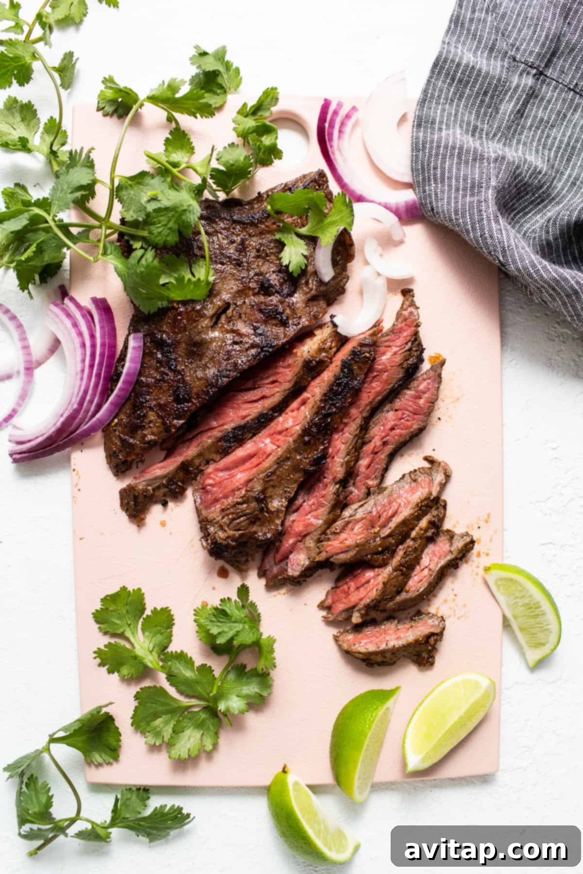 The Perfect Skirt Steak Recipe 6 Sliced skirt steak on a cutting board, ready to be served.