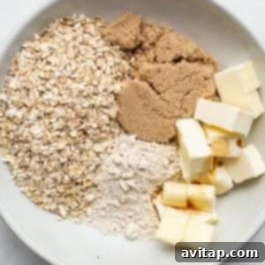 Oats, butter, brown sugar, and vanilla extract in a bowl, being mixed for streusel.