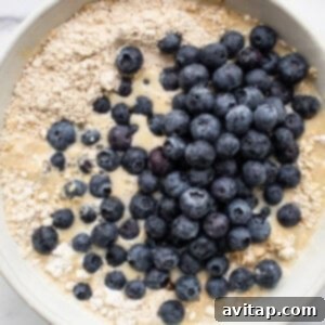 Blueberry oatmeal batter in a white bowl, ready for transfer.