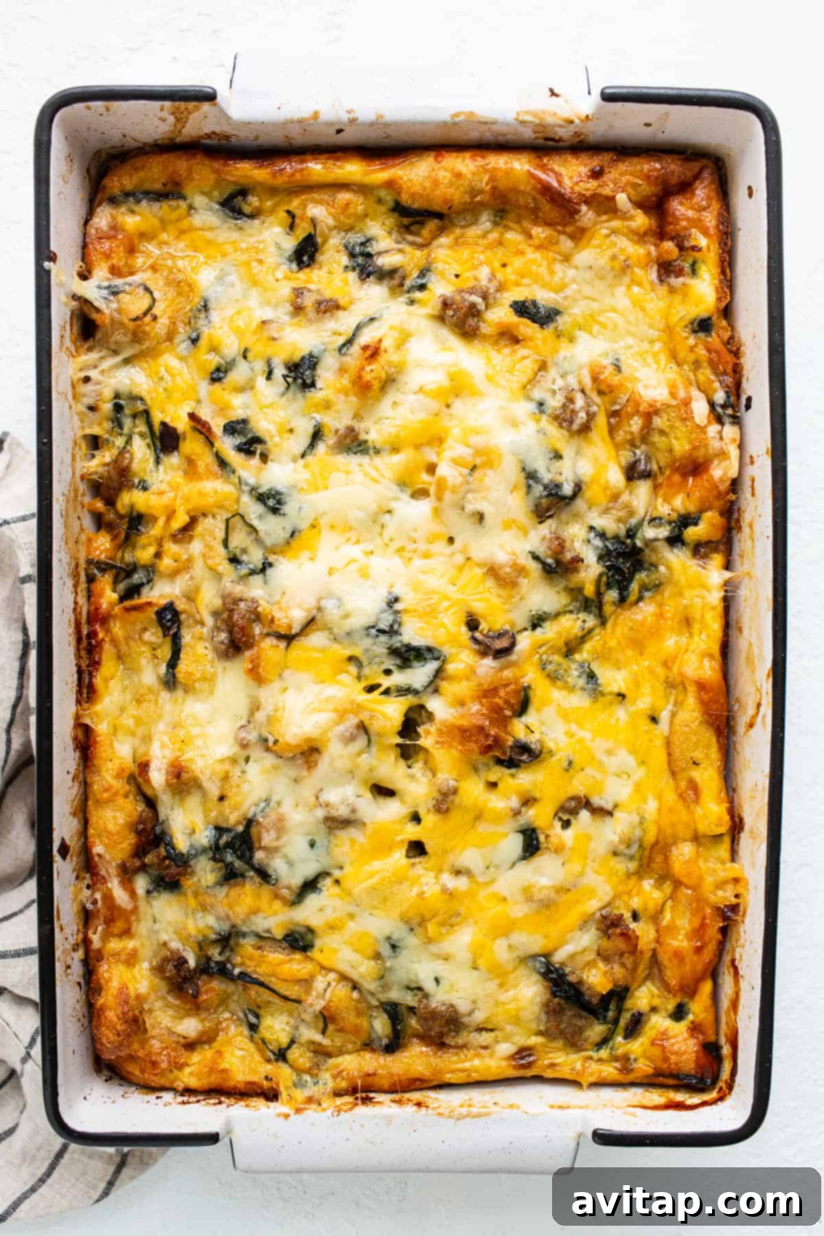 Beautifully baked breakfast strata in a casserole dish, fresh out of the oven, with a golden-brown top.