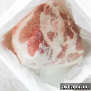 Ham brining in a large container of water.