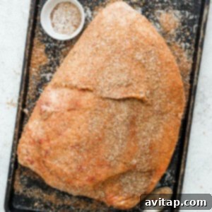 Dry rub evenly applied to the surface of a ham.