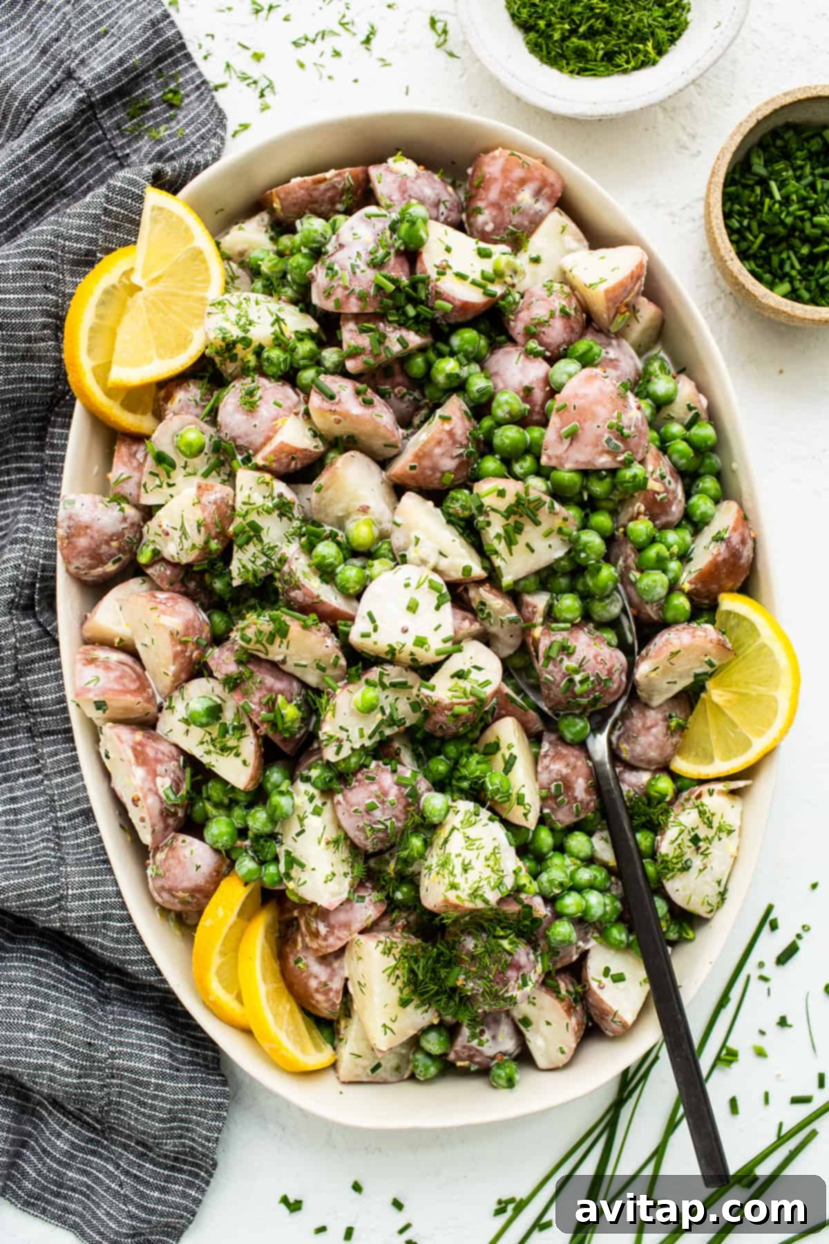 English pea and potato salad in a serving bowl.