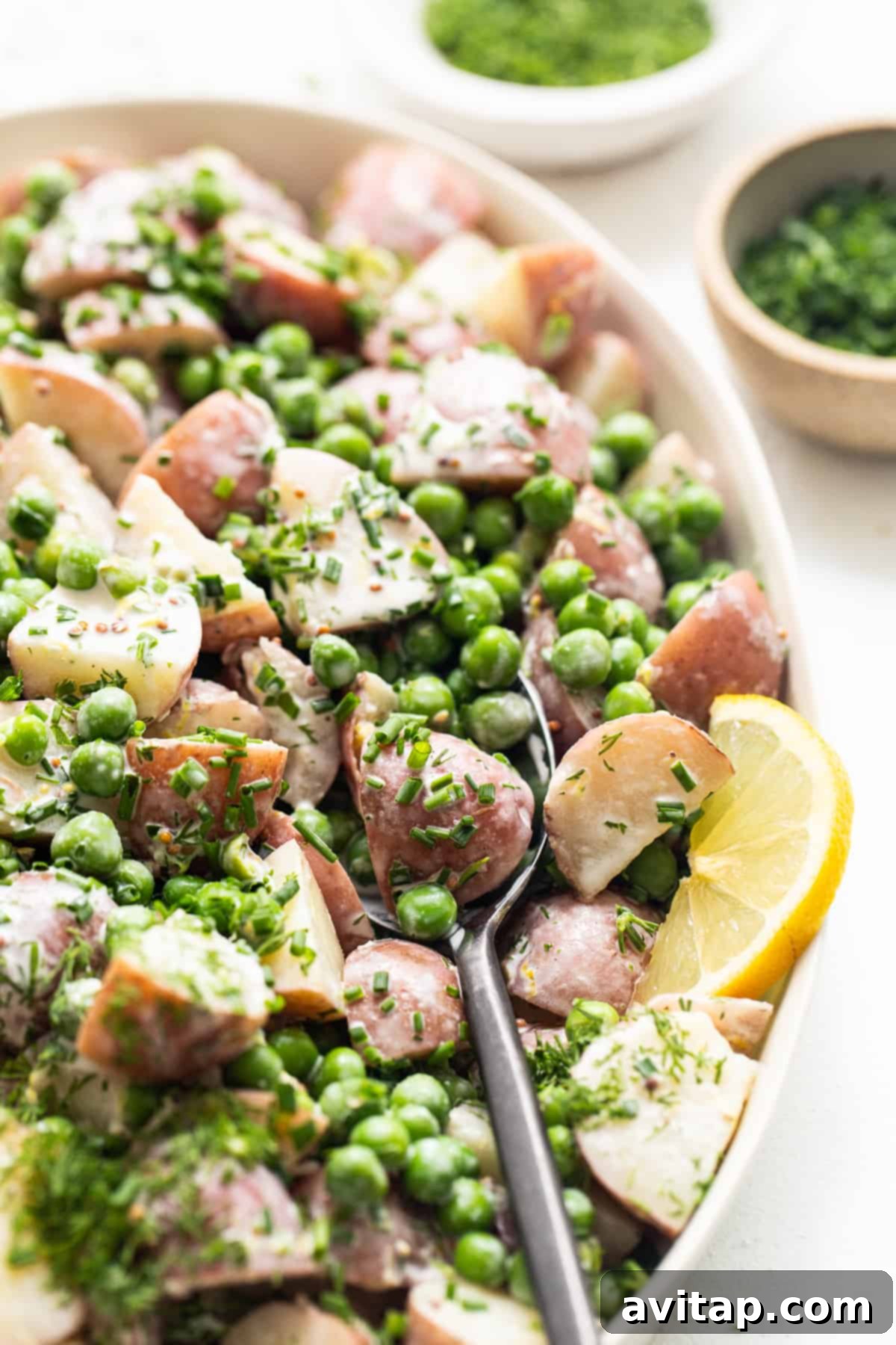 English pea and potato salad in a serving bowl.