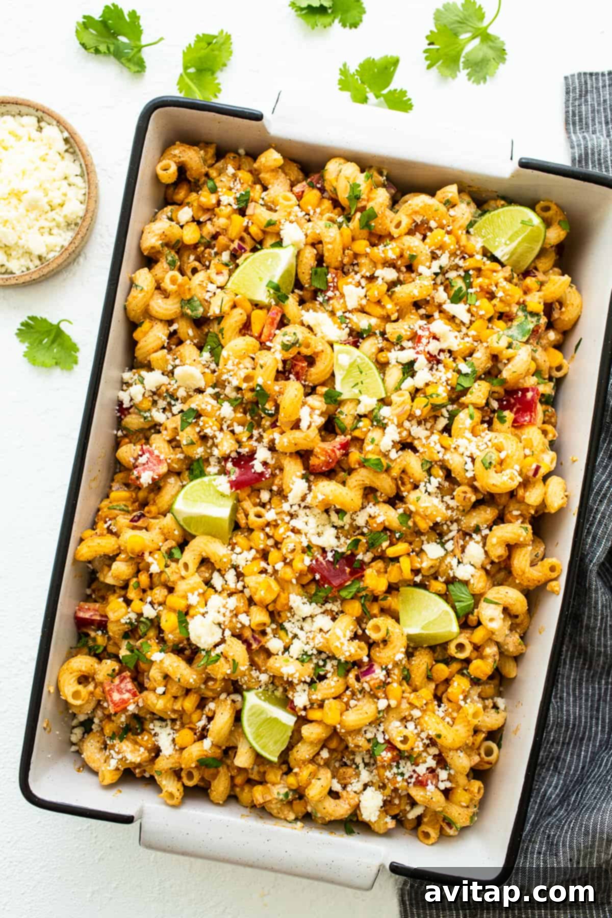 Mexican street corn pasta salad stored in a clear container, perfect for meal prep.