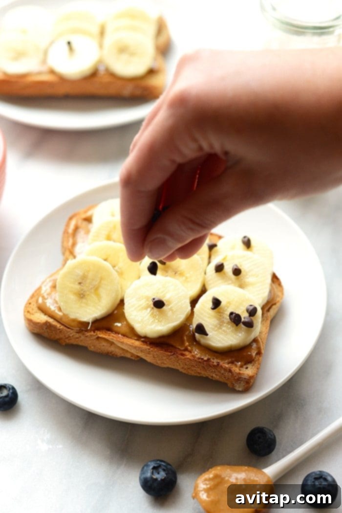 toast on plate topped with banana and mini chocolate chips