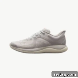 A light grey running and training shoe with a crisp white sole, showcasing the Lululemon Chargefeel.