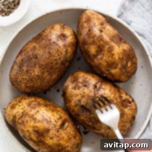 Poking holes into raw potatoes with a fork before cooking.