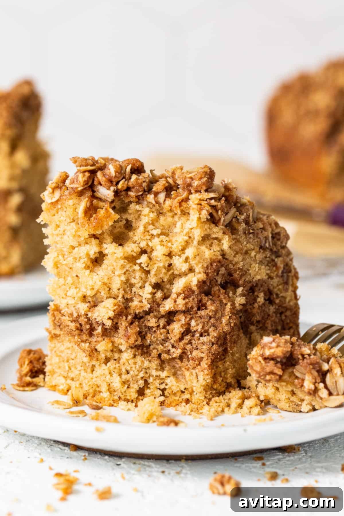 A slice of cinnamon streusel coffee cake on a plate, ready to be enjoyed.
